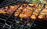 Grilled ribs sizzling on the barbecue