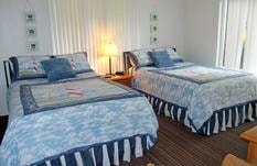 Bright bedroom interior at Sea Escape Oceanfront Lodging