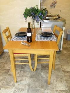 Kitchen dining table with yellow chairs at Sea Escape