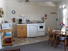 Full kitchen with appliances and dining space